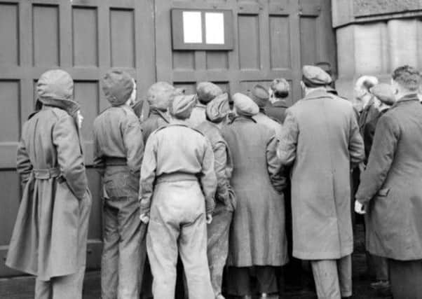 Crowds gather to view a notice of execution outside Wandsworth Prison in 1946, Capital punishment was abolished in Britain in 1965