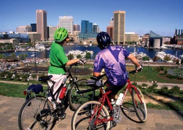 Tourists on bikes at Baltimore Inner Harbour in Maryland, USA