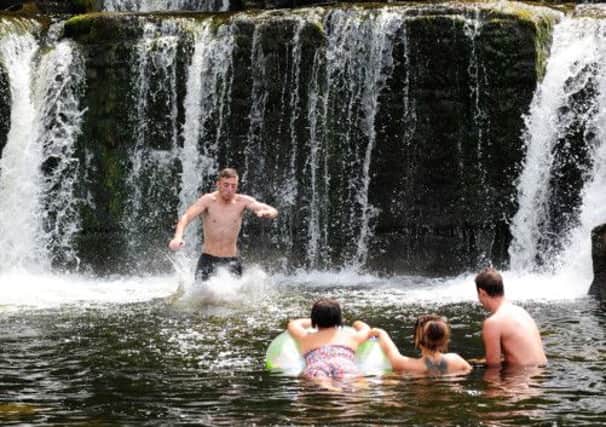 Thrill seekers jumping into the river Swale at Richmond Falls on the hottest day of the year.  Picture: Ross Parry Agency