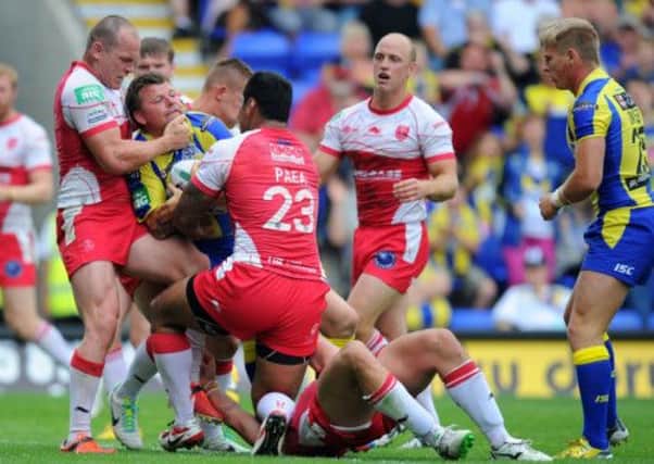 Warrington Wolves' Lee Briers is held up at the line by Hull Kingston Rovers' Rhys Lovegrove and Michey Paea