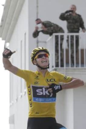 Chris Froome of Britain celebrates as he crosses the finish line of the fifteenth stage of the Tour de France cycling race over 242.5 kilometers (150.7 miles) with start in in Givors and finish on the summit of Mont Ventoux pass, France, Sunday July 14, 2013. (AP Photo/Christophe Ena)