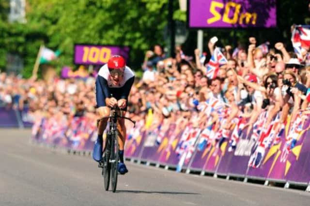 Bradley Wiggins racing towards the finish line during the Men's Individual Time Trial at Hampton Court Palace, London.