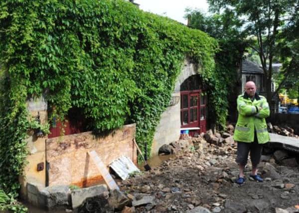 Richard Mountain stands outside his house which was badly damaged by flash floods in Walsden, near Todmorden