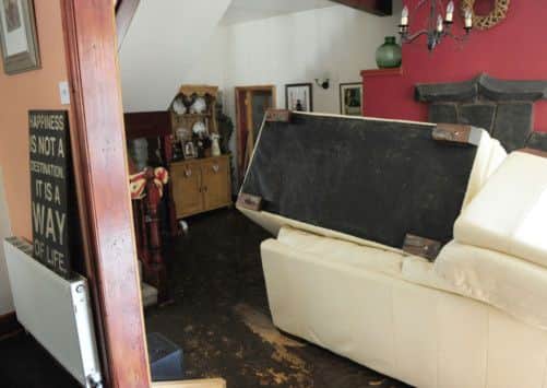 A general view of the flood damaged living room in Richard Mountain's house after flash floods in Walsden, near Todmorden