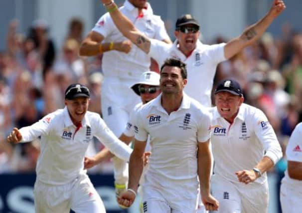 England's James Anderson (centre) and the rest of the England team celebrate winning the First Investec Ashes Test match at Trent Bridge