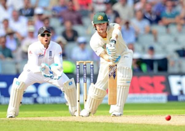 Australia's Michael Clarke plays a shot watched by England Wicket keeper Matt Prior