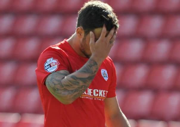 Barnsley's Dale Jennings looks dejected after being given a red card