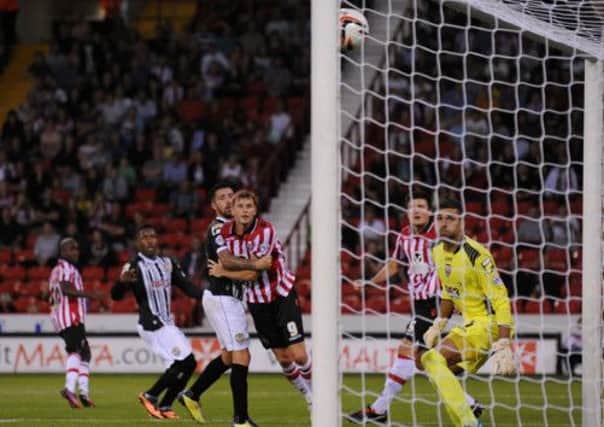 Notts County's goalkeeper Bartosz Bialkowski watches Sheffield United Harry Maguire's (second right) header find the net to make the score 2-1 during the Sky Bet League One match at Bramall Lane, Sheffield.
