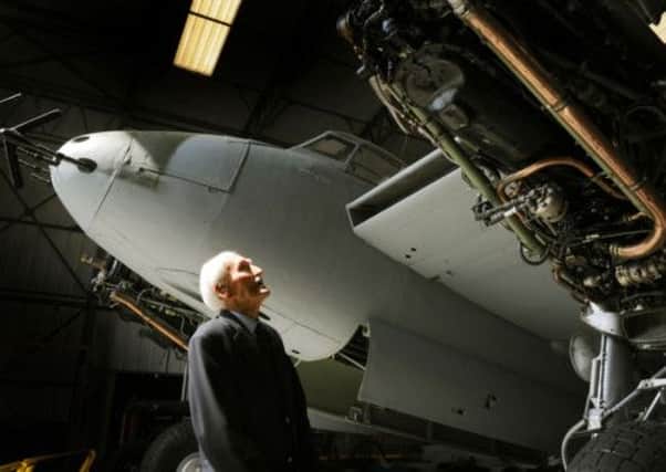 Warrant Officer Paddy Hope, 97, an ex Mosquito navigator takes a close look at the Mosquito aircaft