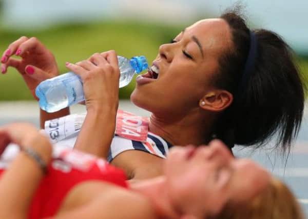 Great Britains Katarina Johnson-Thompson grabs a drink soon after completing the heptathlon 800m in Moscow, narrowly missing out on a bronze medal and finishing fifth.