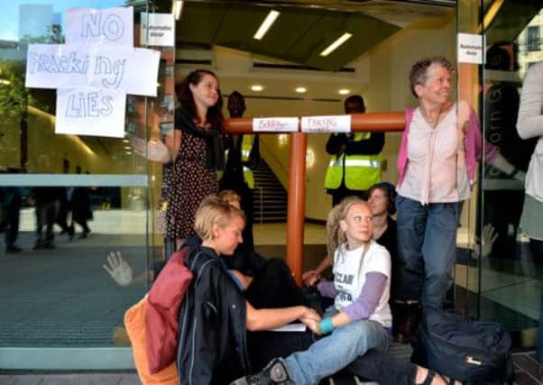 Anti-fracking demonstrators sit with their hands super-glued to each at the offices of Bell Pottinger in High Holborn in central London, the PR company used by energy company Cuadrilla. PIC: PA