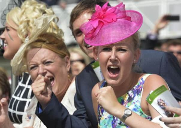 Punters get behind their horse during the third race at York