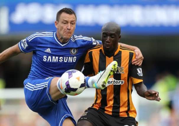 Hull City's Yannick Sagbo (right) and Chelsea's John Terry battle for the ball during the Barclays Premier League match at Stamford Bridge, London.