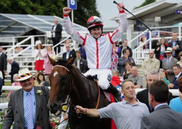 Tom Queally celebrates on Tiger Cliff after his victory in the Betfred Ebor with owner Henry Ponsonby on the left during day four of the 2013 Yorkshire Ebor Festival at York Racecourse, York. (Picture: John Giles/PA Wire)