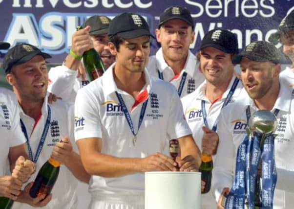 England captain Alastair Cook looks at the Urn as he celebrates winning the Ashes with team mates during day five of the Fifth Investec Ashes Test match at The Kia Oval, London. (Picture: Anthony Devlin/PA Wire).