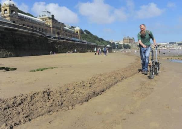 Members of the environmental protest group Scarborough SOS on the beach. Picture: Tony Bartholomew