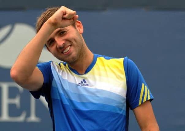 Daniel Evans, of Great Britain, reacts after beating Kei Nishikori of Japan during the first round of the 2013 U.S. Open tennis tournament. (AP Photo/Kathy Kmonicek)