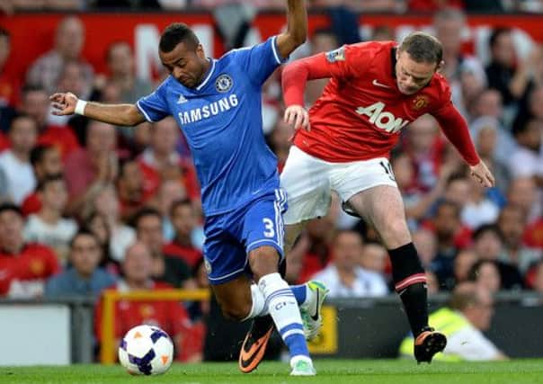 Chelsea's Ashley Cole (left) and Manchester United's Wayne Rooney battle for the ball.