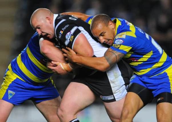 Hull FC's Mark O'Meley is tackled by Warrington Wolves' Matty Blyth.