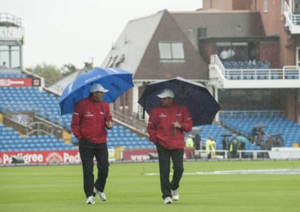 Umpires Richard Illingworth and Aleem Dar inspect the outfield during the First One Day International at Headingley, Leeds.