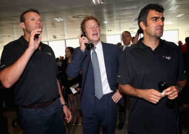 Otley broker Nick Thompson (left) with Prince Harry on the trading floor during the BGC Partners Charity Day in London's Docklands.