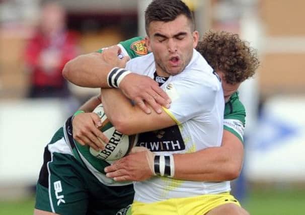 Craig Hampson, is tackled by Nottingham's Rupert Cooper.
