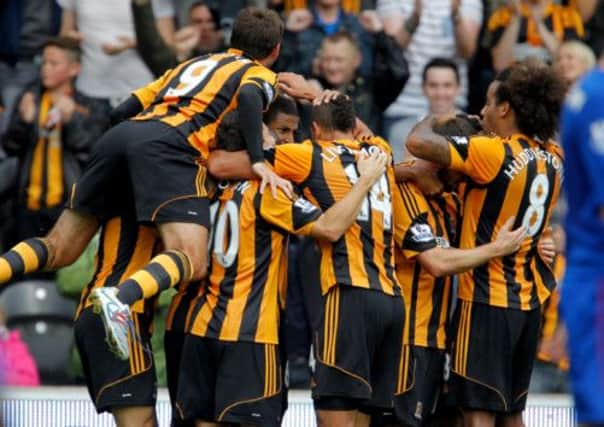 Hull City Tigers' Curtis Davies iis mobbed by team-mates after scoring