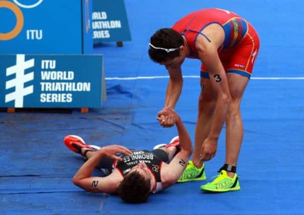 FLAT OUT: Second-placed Jonathan Brownlee, left, is consoled by winner Spain's Javier Gomez after the Elite Mens Pruhealth World Triathlon in Hyde Park. PICTURE: Sean Dempsey/PA.