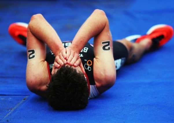 Jonathan Brownlee of Great Britain lies on the ground after finishing second