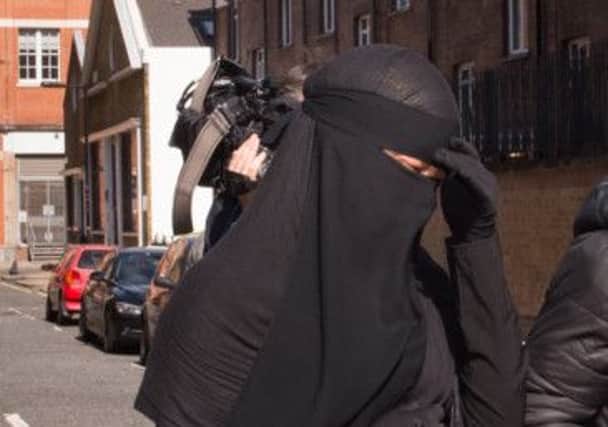 A Muslim woman, who cannot be named for legal reasons, arrives at Blackfriars Crown Court in London