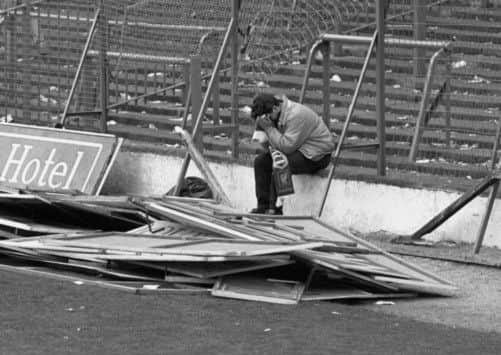 A Liverpool fan sitting on the terraces at Hillsborough after the stadium disaster where 96 fans lost their lives