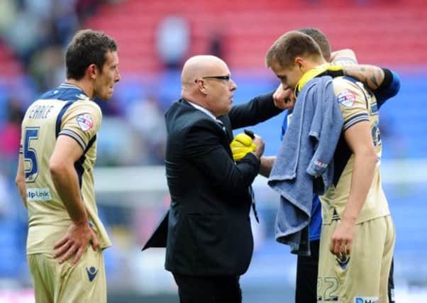 Brian McDermott with players after the Bolton match