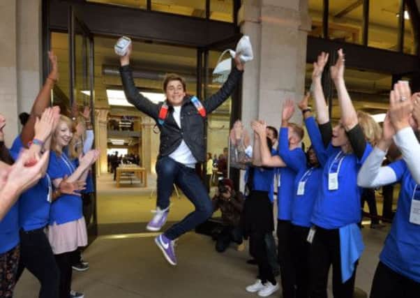 Jesse Green aged 15, from Stanmore jumps for joy as Apple workers applaud him