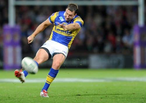 Leeds's Danny McGuire makes the all-important kick three minutes from time. Picture: Steve Riding.