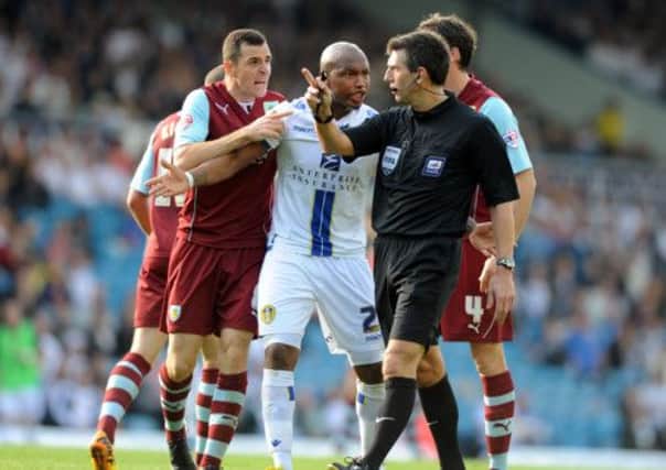 Clarets Dean Marney and Leeds El-Hadji Diouf have strong words with referee Lee Probert