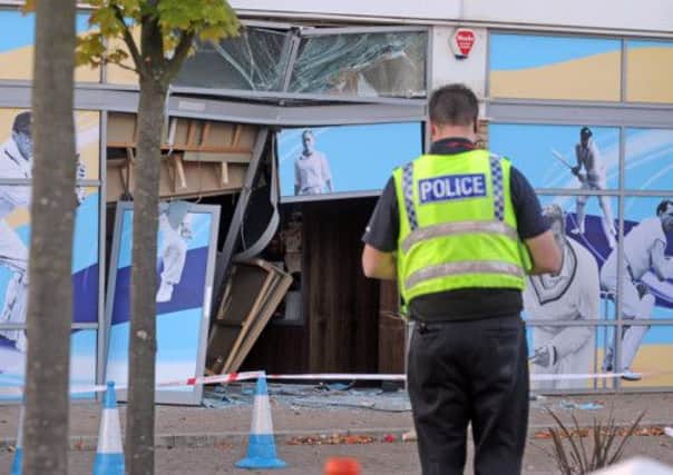 A police officer surveys the damage at Headingley stadium after a car crash.