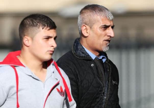 Aftab Khan (right) arriving at Bradford Crown Court