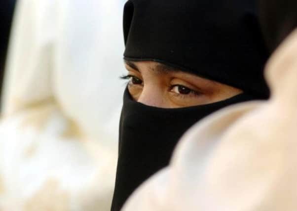 The niqab, the veil worn by some Muslim women, and Imam Qari Asim Mohammed, below.