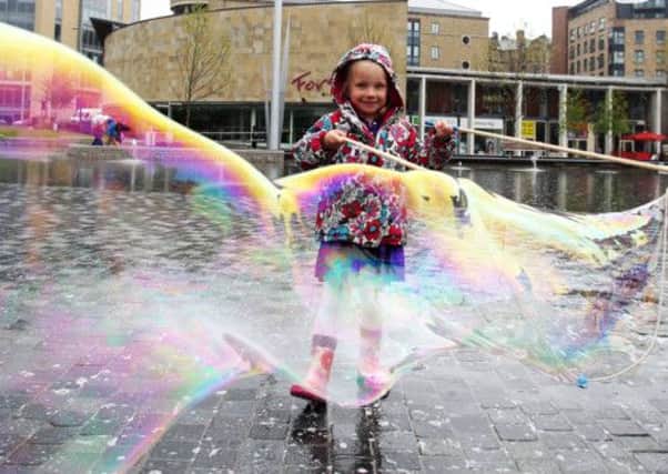 Yeva Baruch has fun with bubbles in Centenary Square
