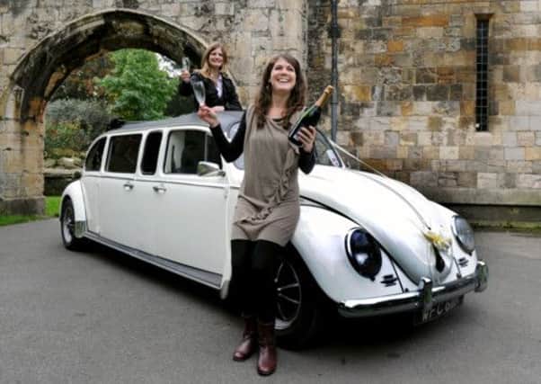 Melody Beavers (left) and Jennifer Cork with a strtched Volkswagon Beetle outside the Hospitium in the Yorkshire Museum Gardens in York