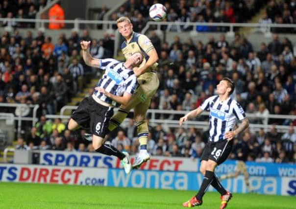 KNOCKED OUT: Leeds Matt Smith gets above Magpies Mike Williamson but his header is saved. Picture: Tony Johnson.