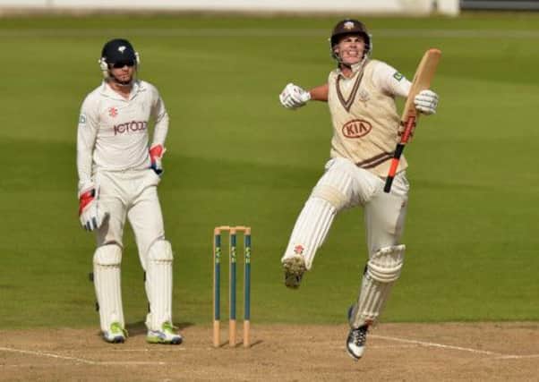 Surrey's Dominic Sibley celebrates making his maiden first class century and becoming the youngest ever player for Surrey at 18 years of age to make a century
