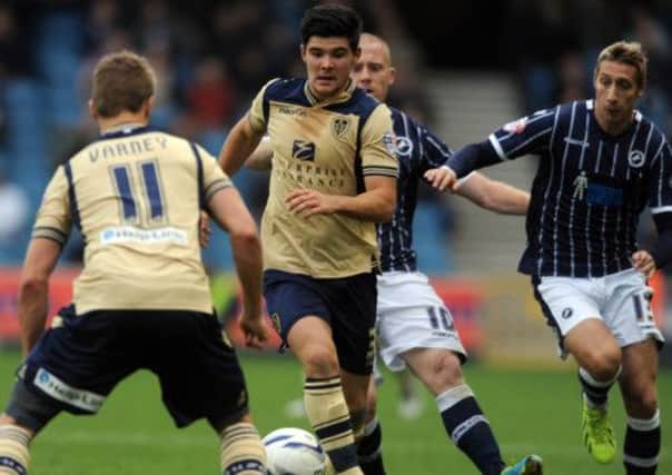 United's Alex Mowatt, is closed down by Millwall's Nicky Bailey, and Lee Martin.
