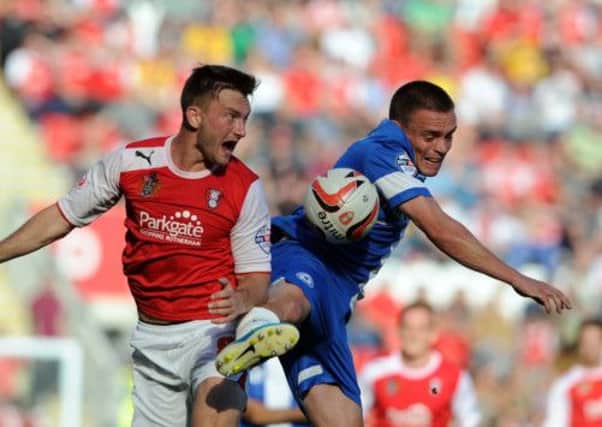 Rotherham player Lee Frecklington battles for the ball with Peterborough player Paul Taylor.