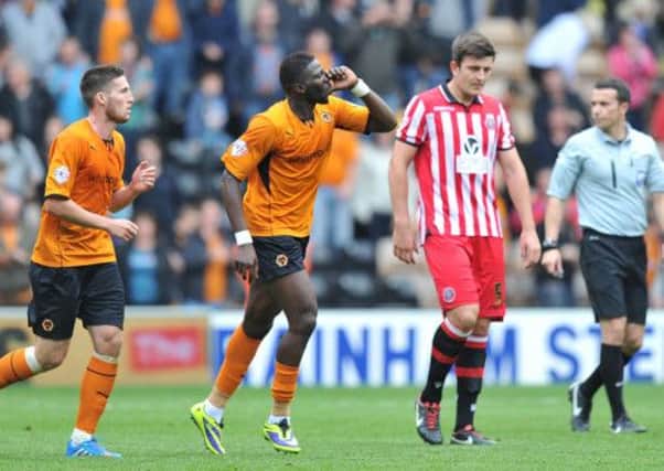 Wolverhampton Wanderers' Bakary Sako (second left) celebrates scoring his sides second goal during the Sky Bet League One match at the Molineux, Wolverhampton.