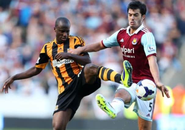 Hull City's Sone Aluko and West Ham United's James Tomkins