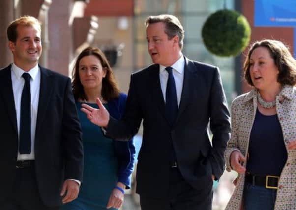 Prime Minister David Cameron (centre) arrives at Manchester Central
