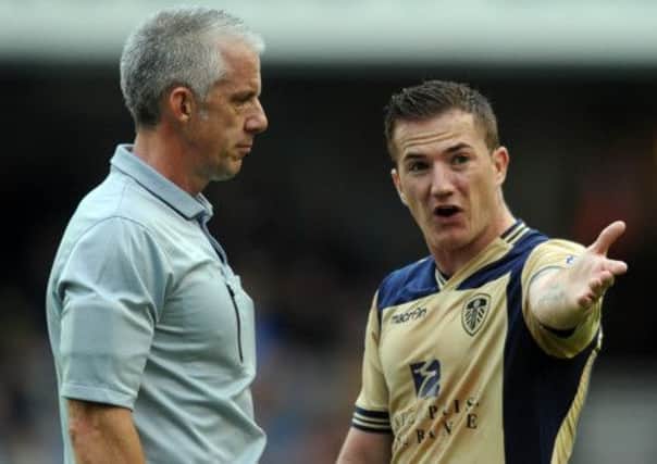 Leeds United's Ross McCormack, has words with referee Christopher Foy at The Den