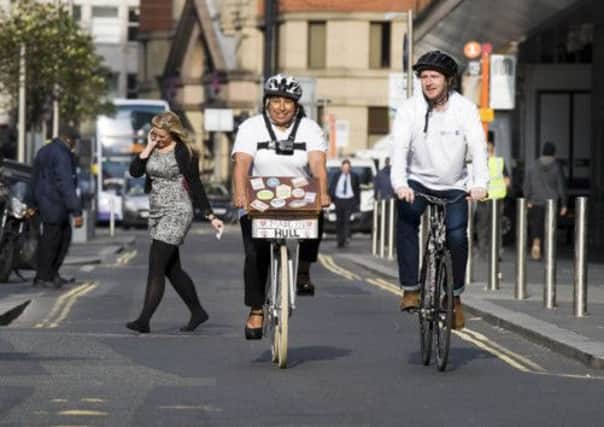 Bid Documents are delivered by bike to offices in Manchester today by Hull actor Matt Sutton and Karen Okra of Black History Partnership and the Freedom Festival Board.
 Picture: Sean Spencer/Hull News & Pictures