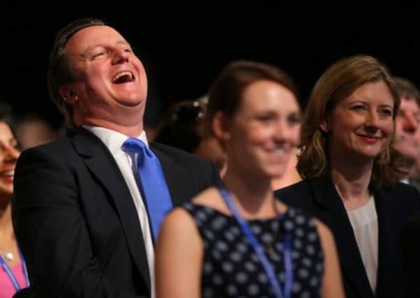David Cameron laughs as he sits alongside Frances Osborne, wife of the Chancellor